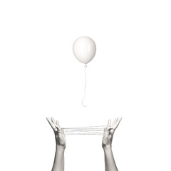 conceptual freedom image of a white balloon escaping from a human trap