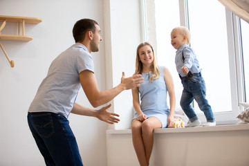 Fototapeta premium Mom, dad and little son are playing at home. Young family with a child.