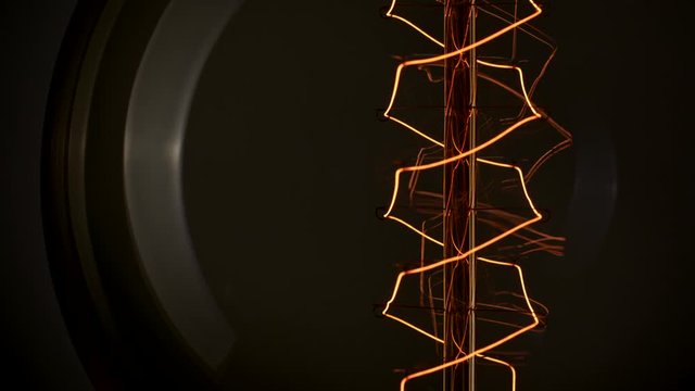 Power outages. Light blinking on Edison lamp in dark room. Close-up shot, 4K