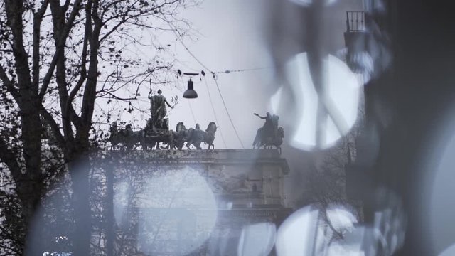 Smooth camera movement with amazing bokeh. statues of horses on the arch of peace in Milan in Italy. Concept of discovering european city.