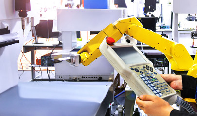 Engineer check and control automation yellow Modern Robot system in factory, Industry Robot concept...