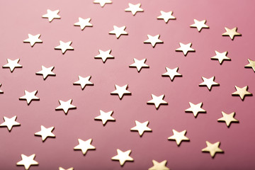 Fototapeta na wymiar Pinky holiday background with golden stars