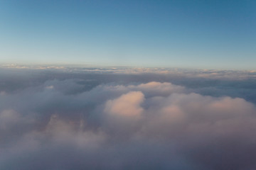 Sky with clouds at sunset from inside the plane landscape