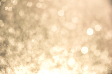 Abstract bokeh light on black background with flare. Christmas concept to present celebration wallpaper decor with beautiful glitter and sparkle bubbles in blur or defocus style for web design.