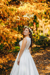 Obraz na płótnie Canvas Bride in wedding dress on natural background. Wedding day.