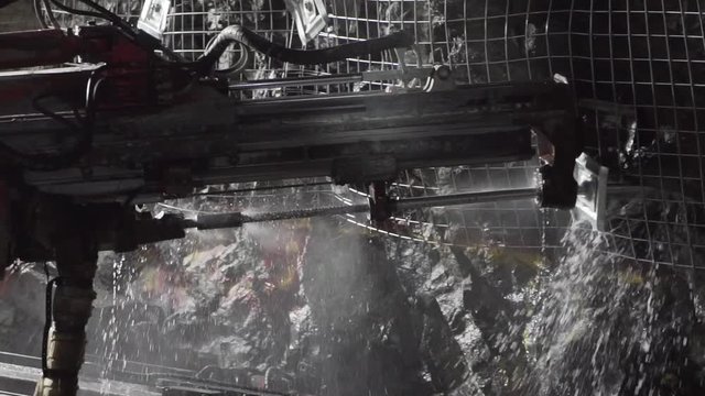 Jumbo drilling rod into hard rock in underground gold mine