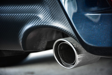 Close-up car exhaust pipe,Exhaust pipe of a diesel car,New generation of sportive mufflers,Double Car Exhaust Pipe chromed made of stainless steel,Stainless exhaust pipe at the bottom of car.
