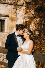 Fototapeta premium Loving couple in wedding clothes. Autumn day