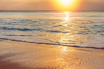 Fototapeta na wymiar Golden sunset at sea beach