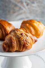 croissants and buns on a white plate