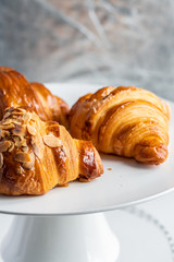 croissants and buns on a white plate