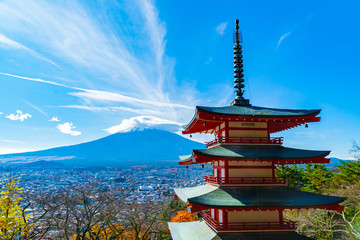 Beautiful view from Chureito Pagoda in Autumn season with mountain Fuji wearing hat in the background. Fujiyoshida, Japan.