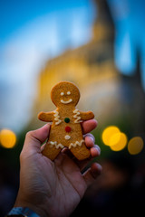 Gingerbread man in man hand holding with night light background in Christmas event and bokeh lights.