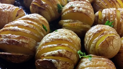 Sliced baked buttered potatoes ready to be served