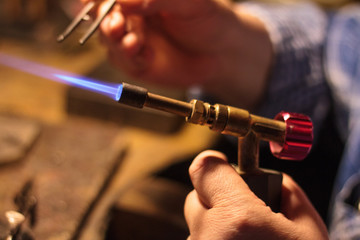 Old jeweler at work on his studio  - 310432551