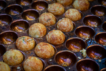 Takoyaki - The traditional Japanese food at Kuromon Market, the most famous market in Osaka, Japan.