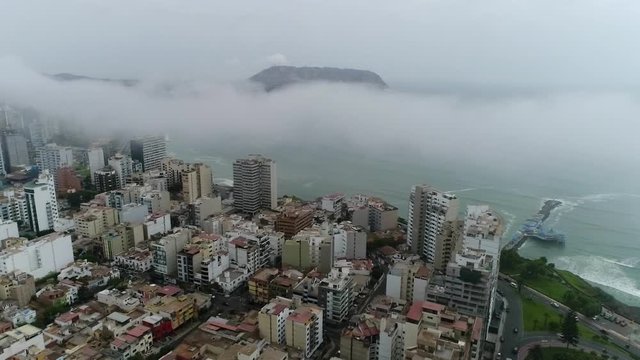 drone view over Lima Peru, high buildings and ocean on the background