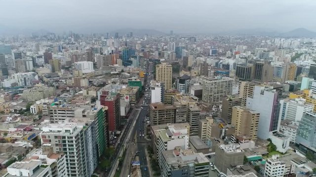 drone view over Lima Peru, high buildings and ocean on the background