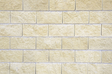 Old beige stone wall background texture