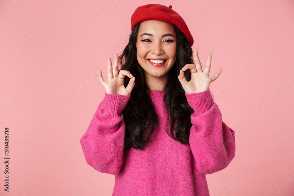 Sticker Image of young asian girl wearing beret laughing and showing okay sign