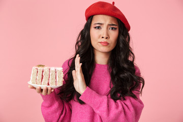 Image of asian girl doing no gesture while holding piece of cake