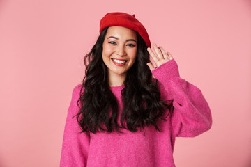 Image of positive beautiful asian girl with long dark hair waving hand