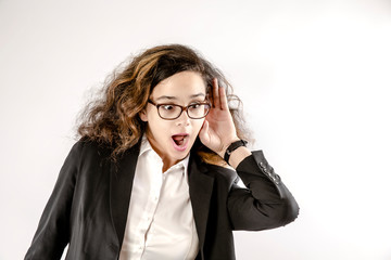 young pretty woman looking shocked and curious, listening, trying to hear a secret conversation or...