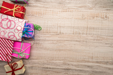 Colorful gift boxes on wooden table top view. Presents, new year and Christmas celebration