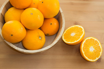Delicious sweet oranges on wooden background