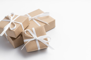 Brown gift box tied with white ribbon on clear background