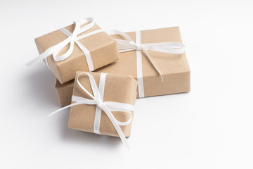 Brown gift box tied with white ribbon on clear background - 310438582