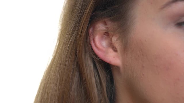 An extreme close-up of the hole of a woman's pierced ear