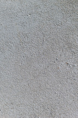Gray textured cement wall background with fine concrete chips. Construction backgrounds