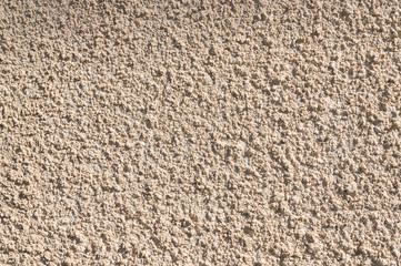 Coarse-grained textured gray background cement finish of the building facade with cement putty