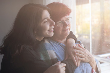 Smiling mother with her teenage daughter