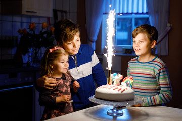 Adorable little toddler girl celebrating third birthday. Baby sister child and two kids boys...