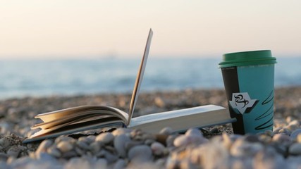 Cup Of Coffee and book on sea background
