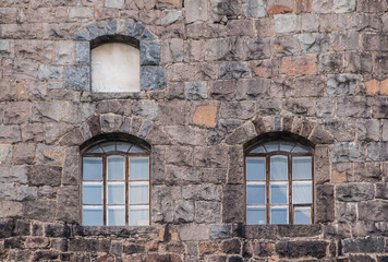Fototapeta na wymiar Several windows in the stone wall of the Vyborg Castle front view, Vyborg, Leningrad Oblast, Russia