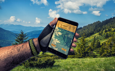 Smartphone GPS navigator in man's hand.
