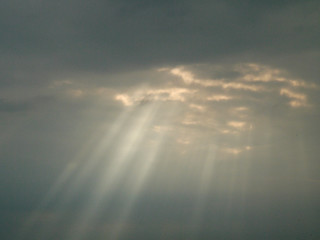 Fototapeta premium Cloudy grey sky with rays of light. Nature background.