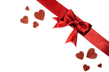 Romantic background with satin red bow and red hearts with sequins. For your text