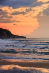 View of the bay of Peschici at sunset: sandy beach with on background, Italy (Puglia). Peschici is famous for its seaside resorts, its territory belongs to the Gargano National Park.