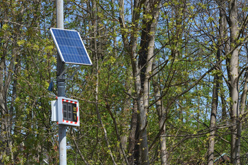 Digital road sign showing speed limit and runs on solar panel in a European city