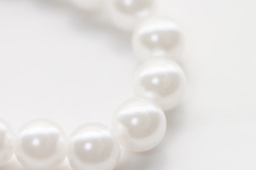 Necklace with shining white pearl isolated background macro