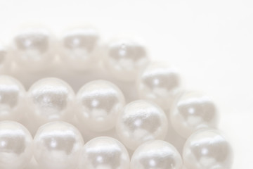 Necklace with shining white pearl three layers isolated background macro