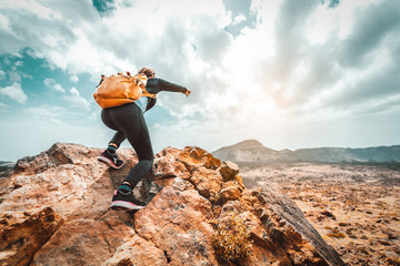 Success woman hiker hiking on sunrise mountain peak - Young woman with backpack rise to the...