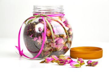 bottle of tea and flowers isolated on white