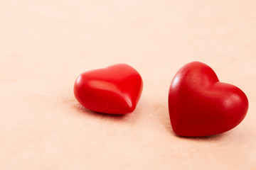 Two red hearts on Pink background