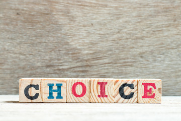 Fototapeta premium Letter block in word choice on wood background