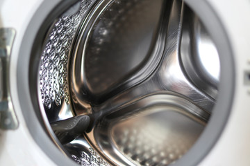 The inside of the front load washing machine is a stainless steel material.